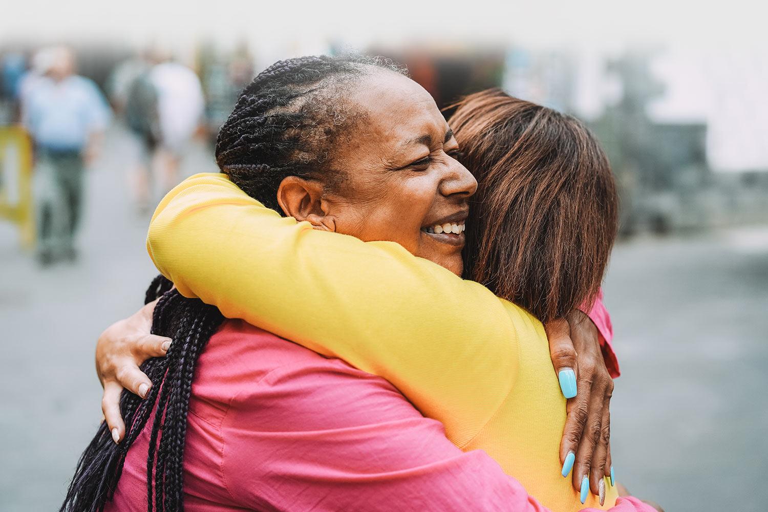 two people hugging happily