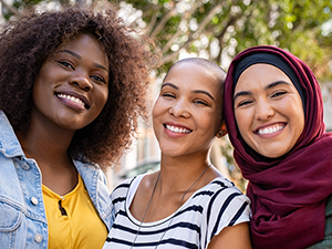 Three women smiling and posing for a picture