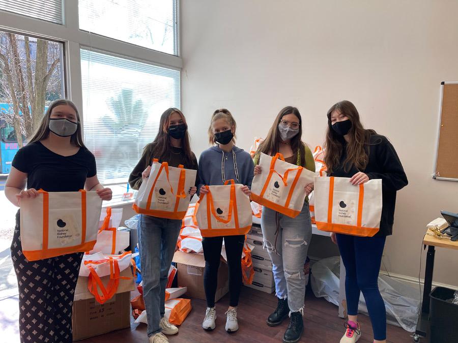 group of volunteers stuffing care packages