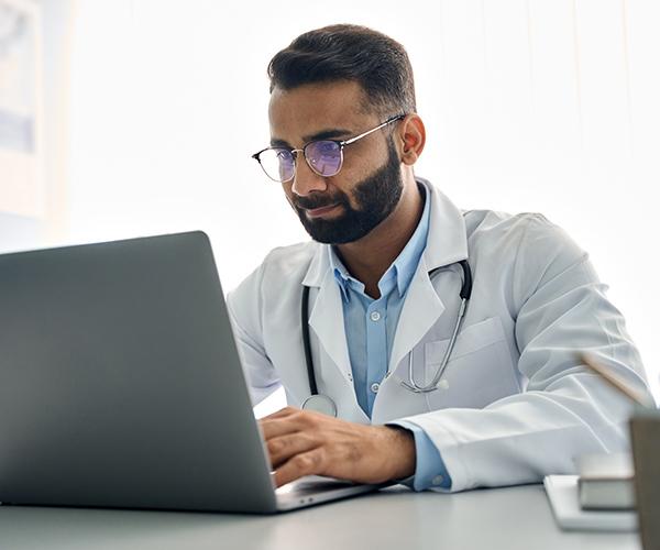 Doctor watching a educational video on a laptop