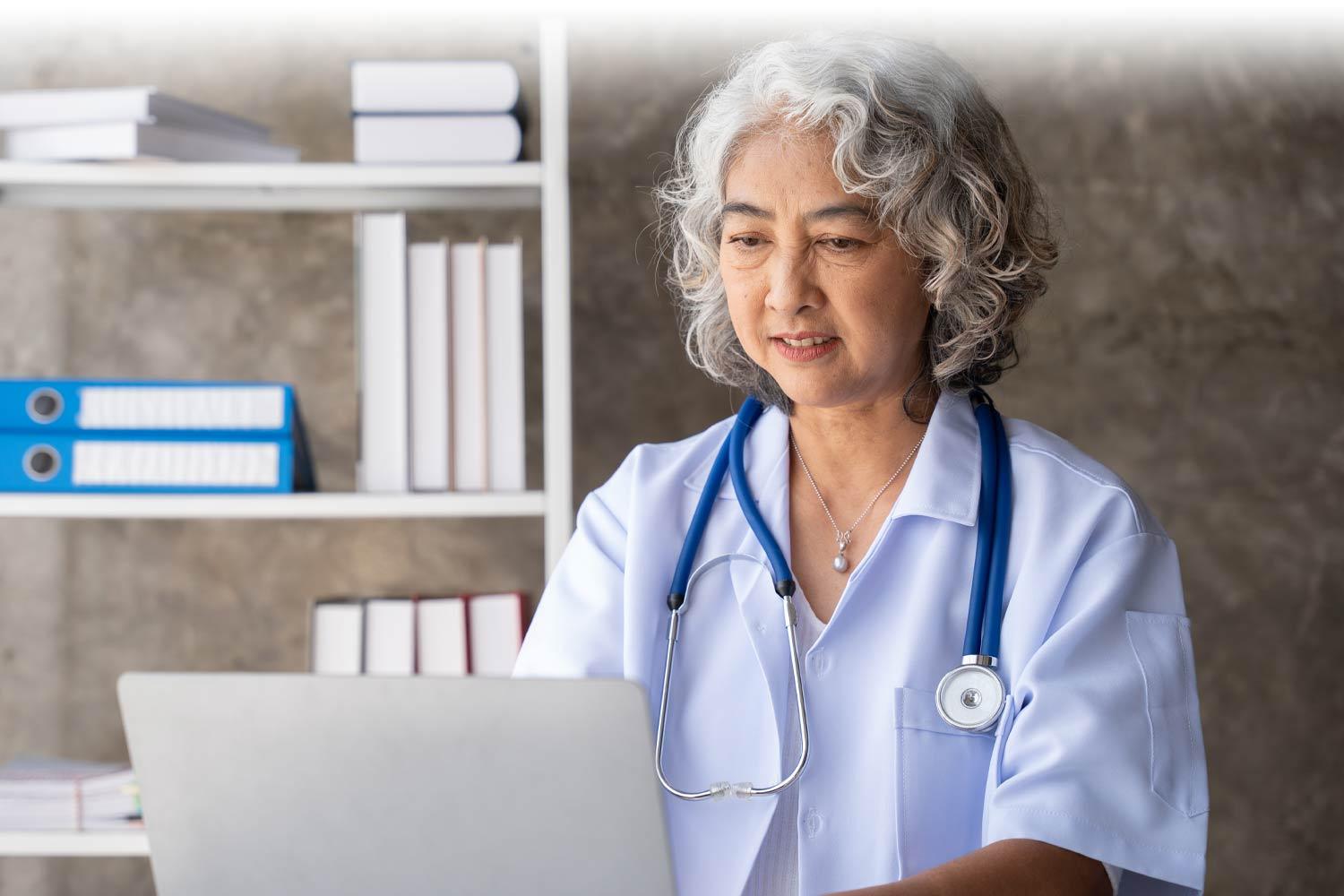 Doctor reading on the computer in her office