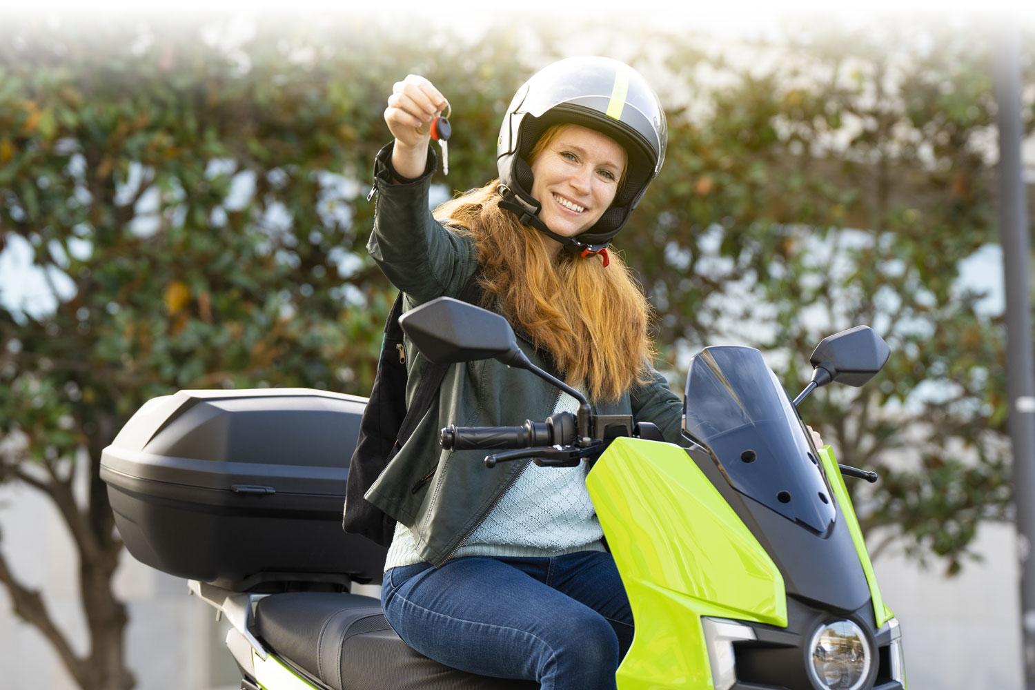 Woman on a motorcycle handing over her keys