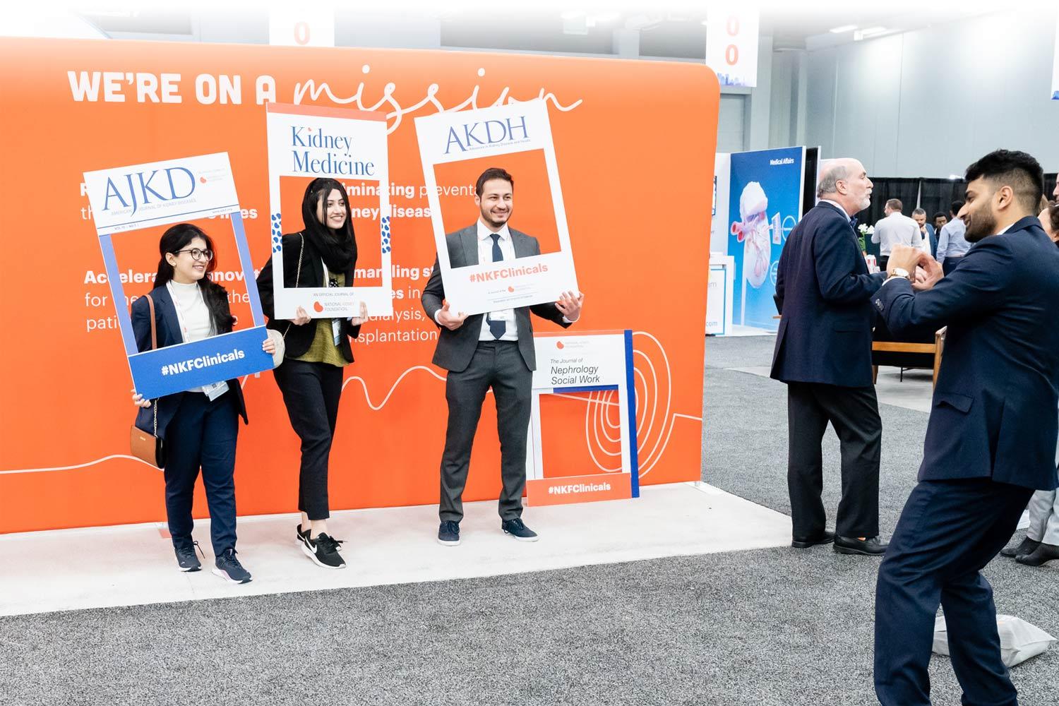 Professionals posing with NKF Professional Journal covers at Spring Clinical Meetings