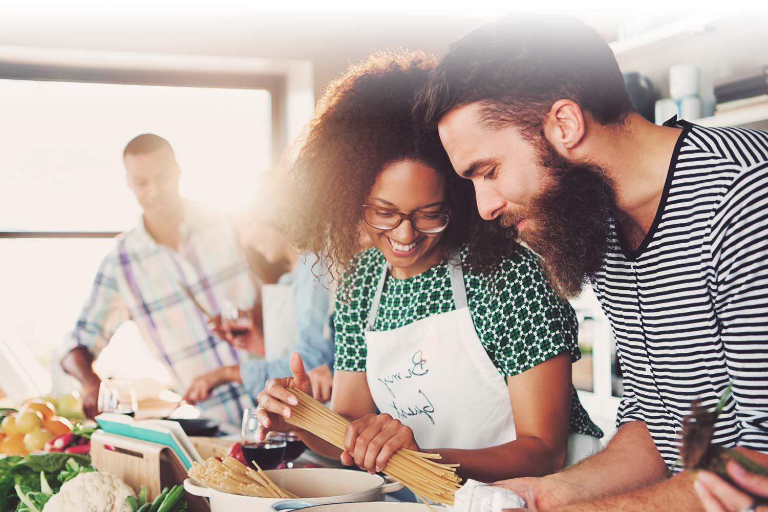 Group of people cooking together in a kitchen