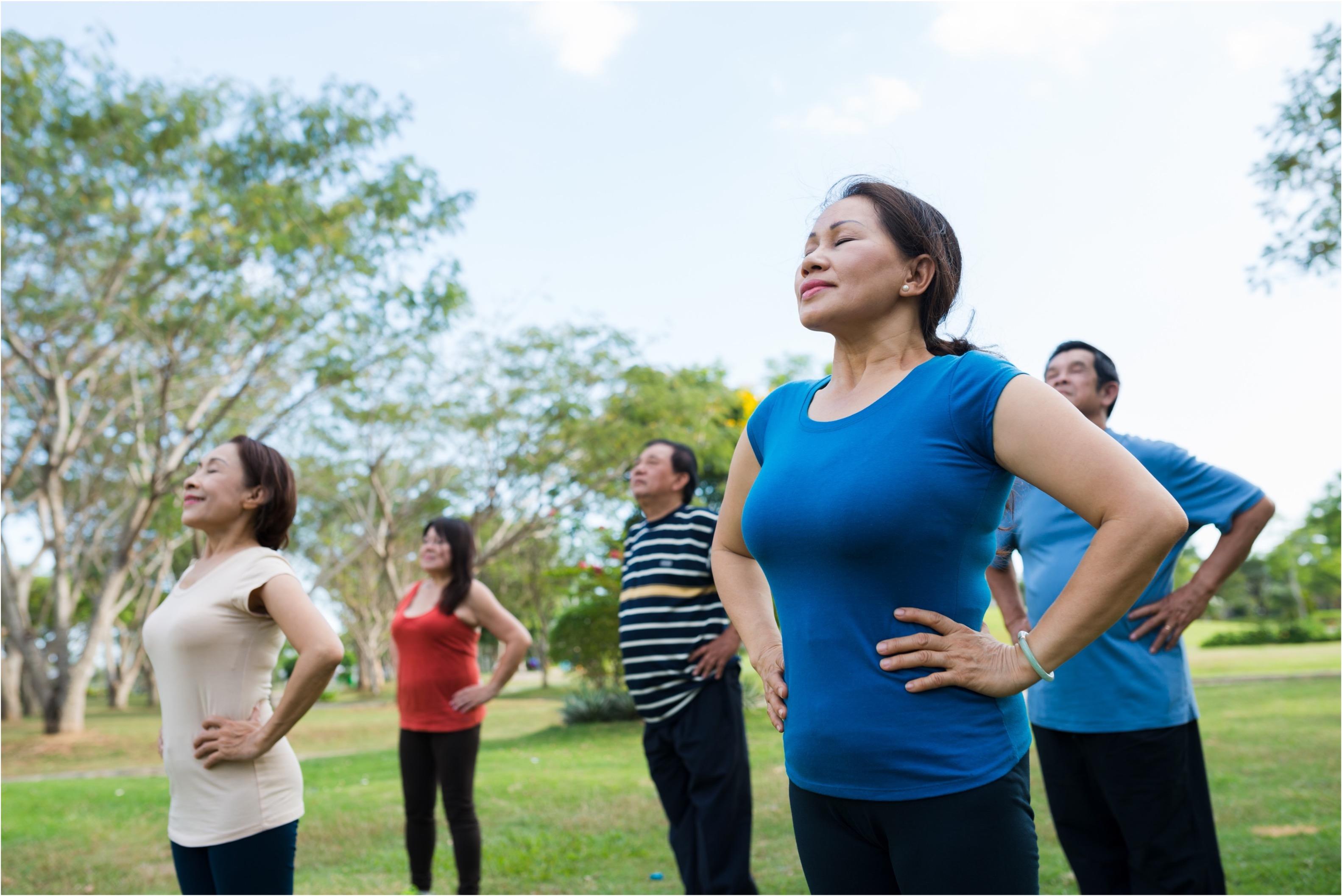 group of people doing tai chi outside