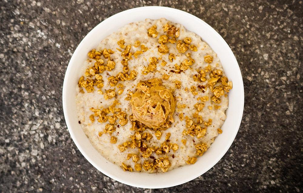 bowl of oatmeal with a scoop of peanut butter on top