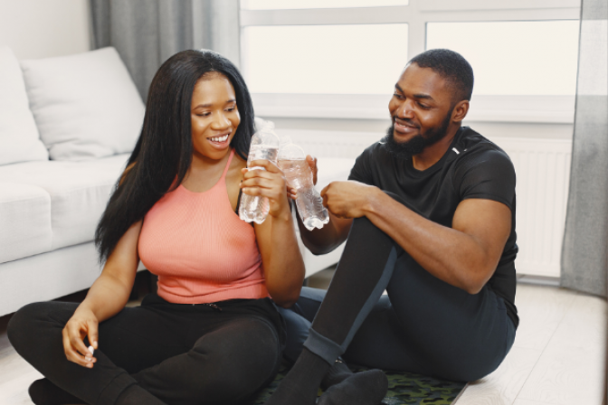 two people toasting with glasses of water